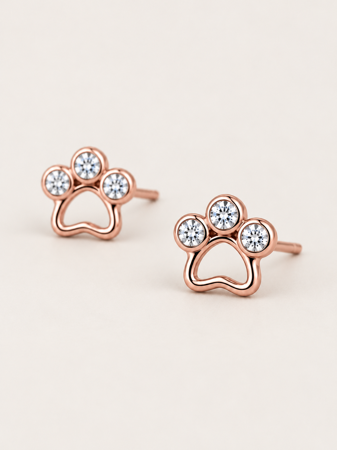 Crystal Paw Print Stud Earrings — Rose Gold angled view