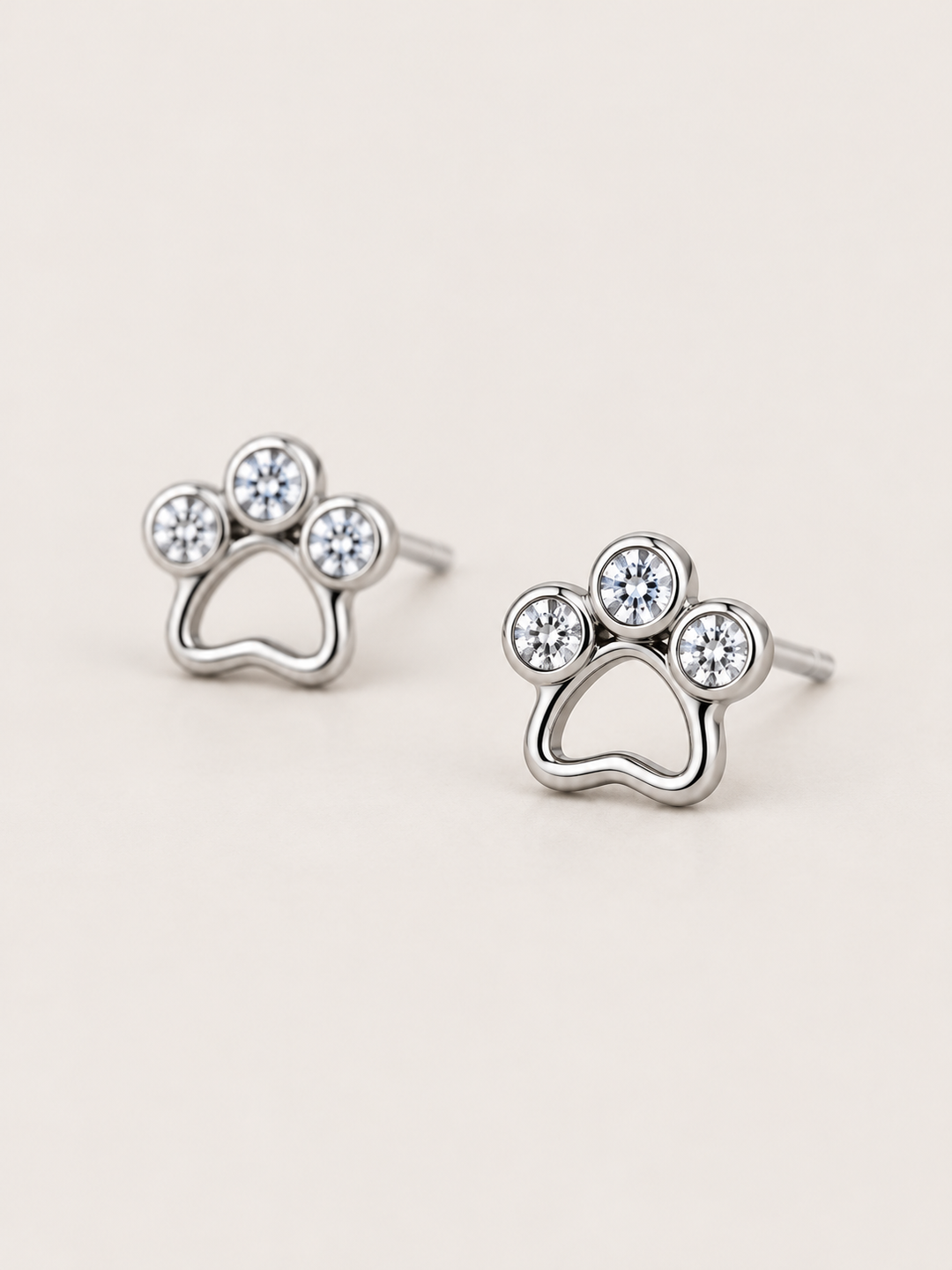 Crystal Paw Print Stud Earrings — Silver angled view