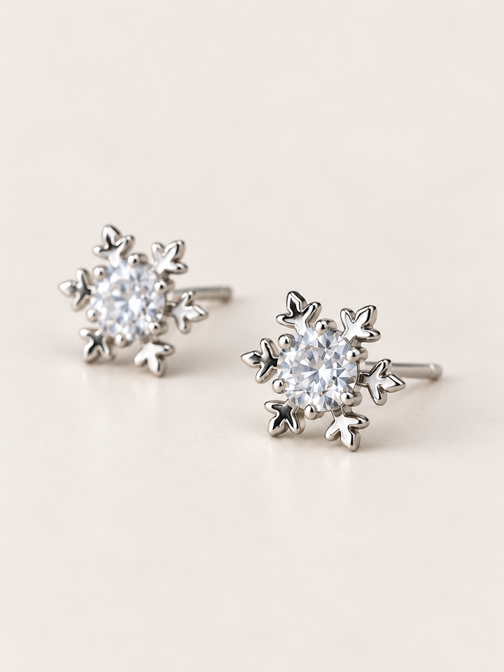 Crystal Snowflake Stud Earrings shown angled on a warm neutral background