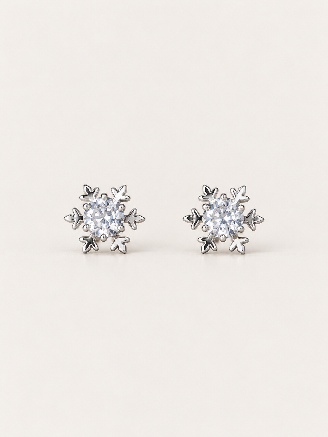 Crystal Snowflake Stud Earrings shown on a warm neutral background