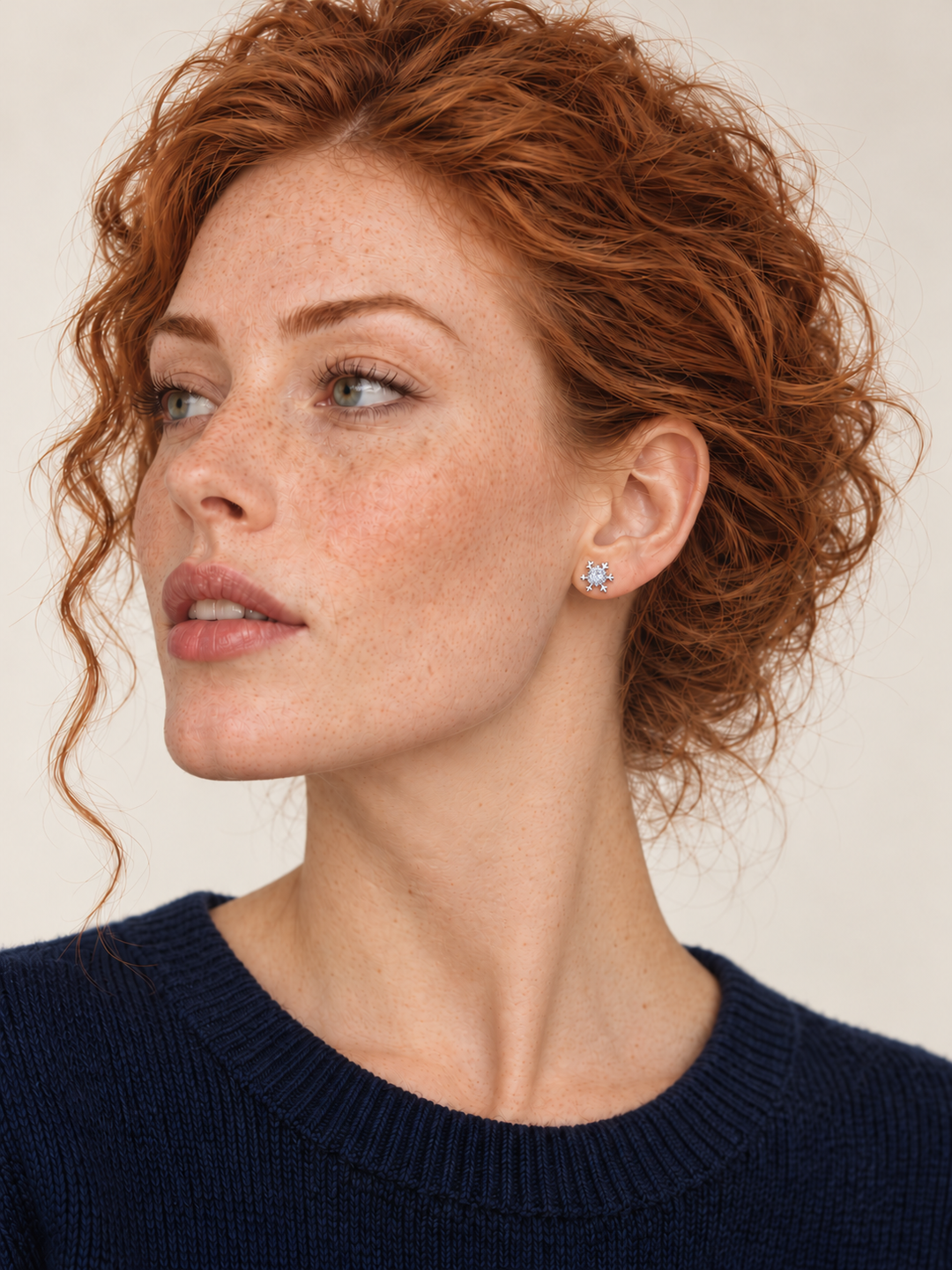 Crystal Snowflake Stud Earrings worn on a model's viewer-right ear