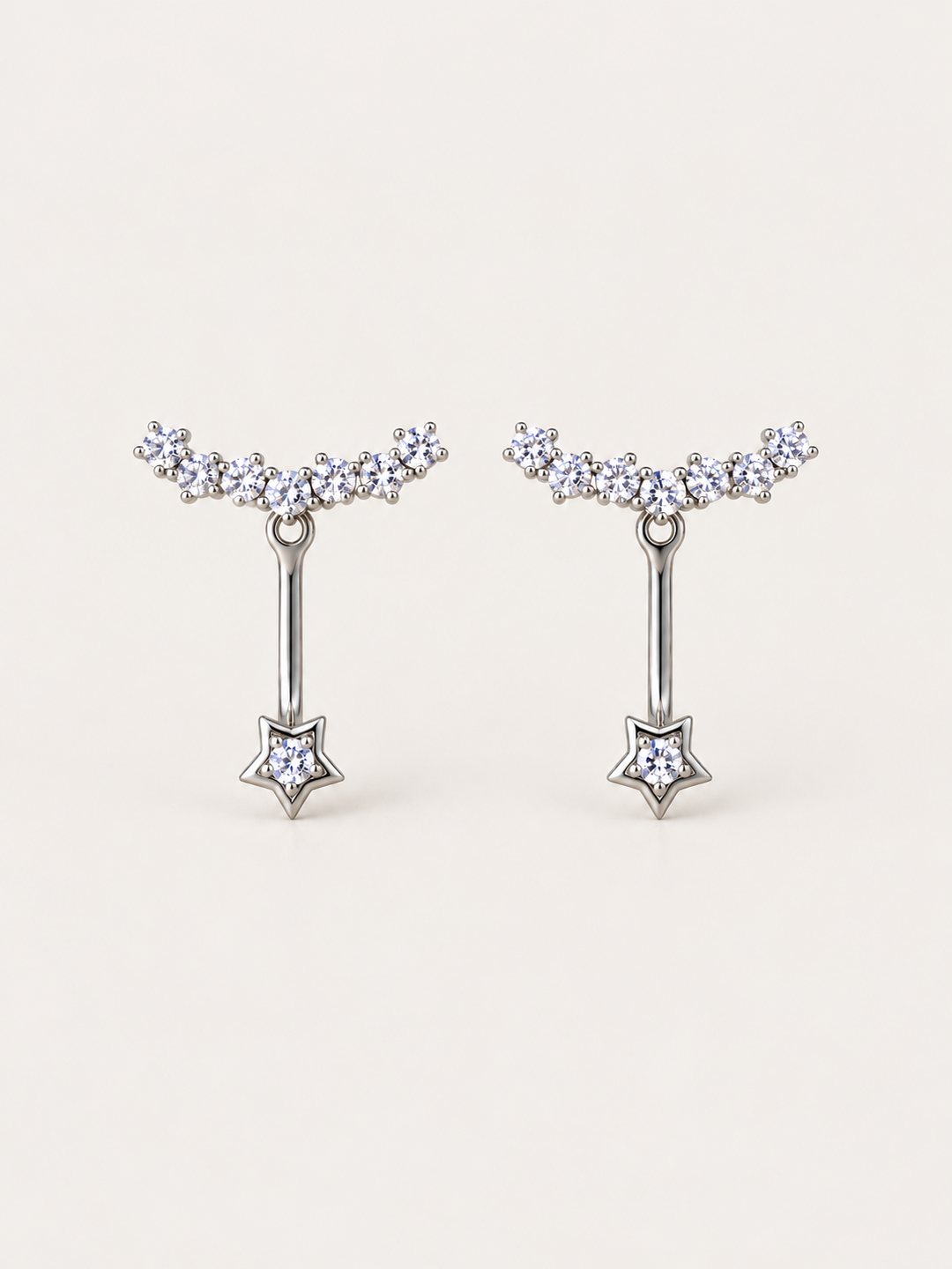 Crystal Star Ear Jacket Earrings shown on a warm neutral background