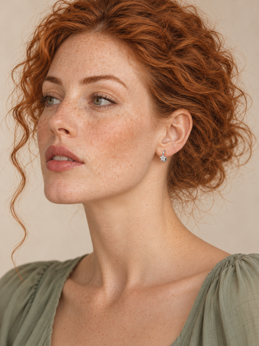 Model wearing Silver Crystal Star Huggie Earrings on the viewer-right ear