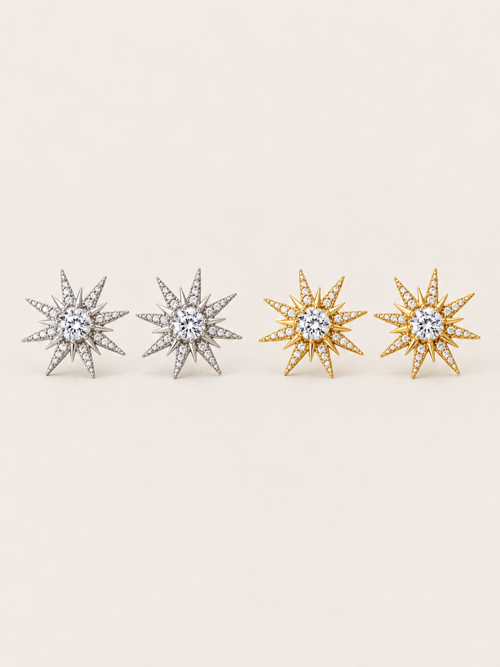Crystal Starburst Stud Earrings in Silver and Gold shown on a warm neutral background