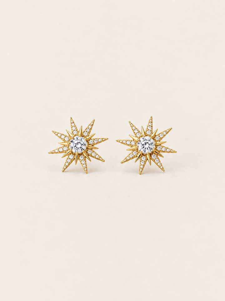 Crystal Starburst Stud Earrings in Gold shown on a warm neutral background