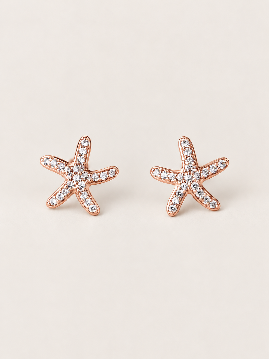 Rose Gold Crystal Starfish Stud Earrings shown on a warm neutral background