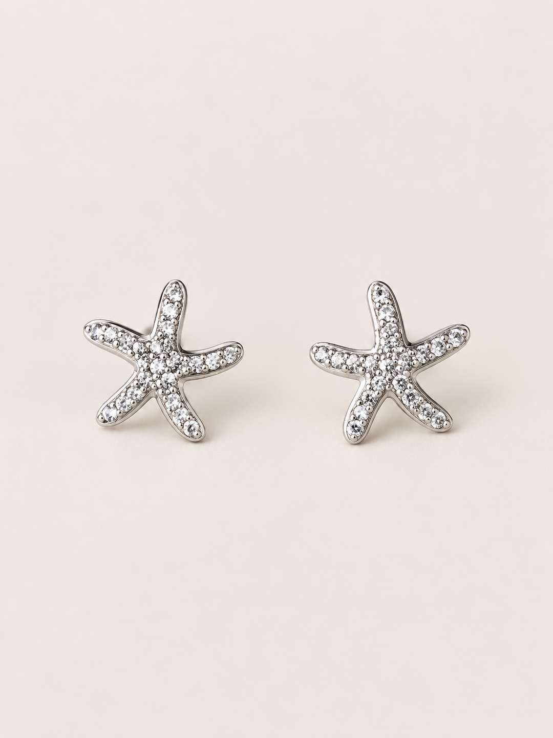 Silver Crystal Starfish Stud Earrings shown on a warm neutral background