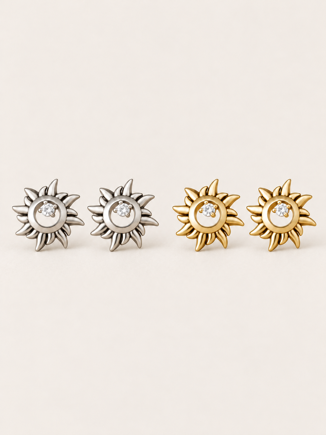 Crystal Sun Stud Earrings in silver and gold shown on a warm neutral background
