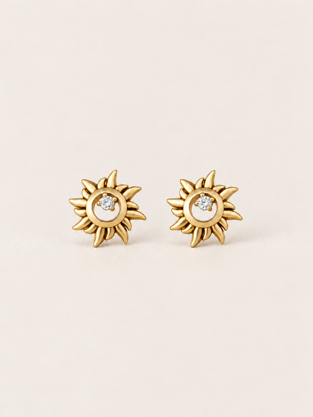 Gold Crystal Sun Stud Earrings shown on a warm neutral background