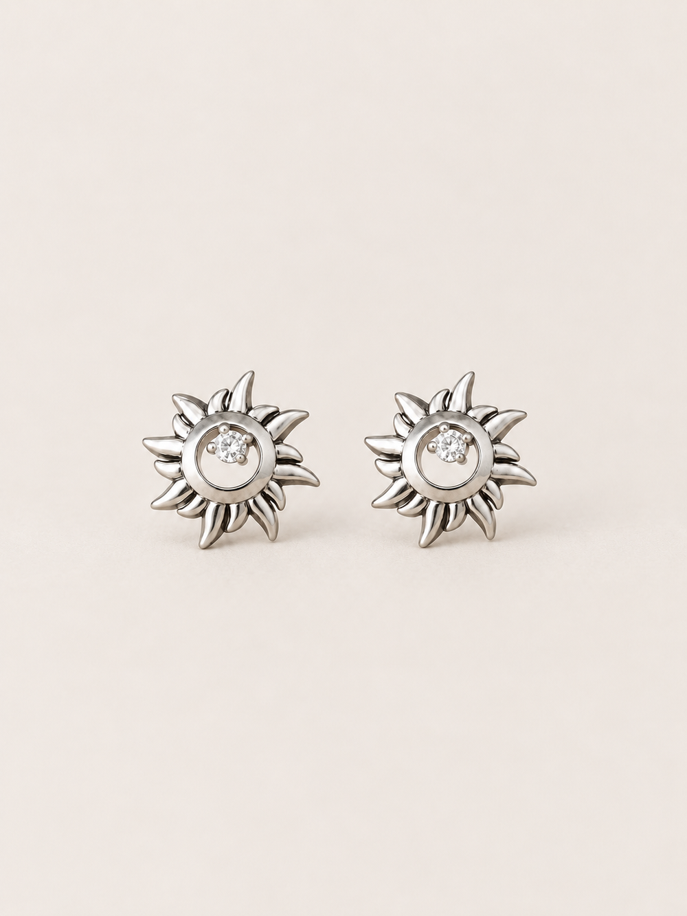 Silver Crystal Sun Stud Earrings shown on a warm neutral background