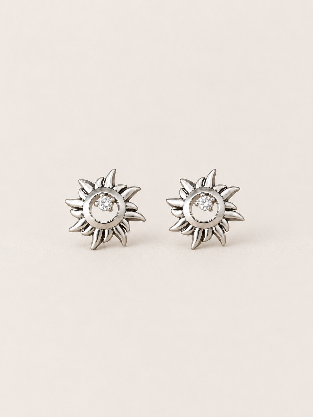 Silver Crystal Sun Stud Earrings shown on a warm neutral background