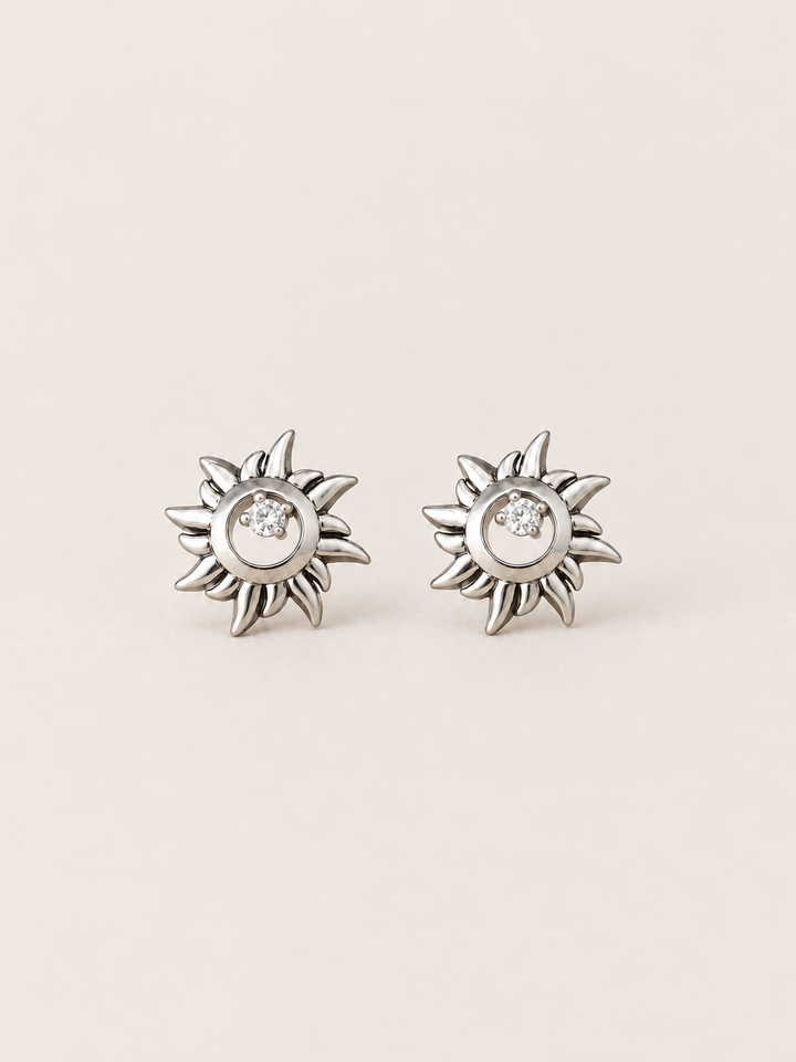 Silver Crystal Sun Stud Earrings shown on a warm neutral background