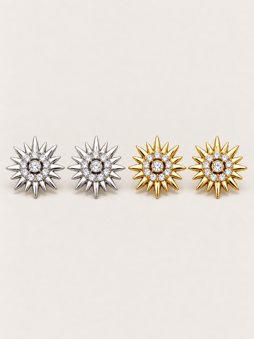 Crystal Sunburst Stud Earrings in Silver and Gold on a warm neutral background