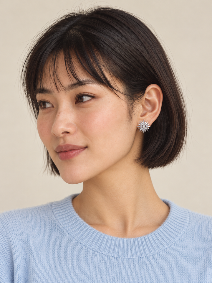 Crystal Sunburst Stud Earrings in Silver worn on the viewer-right ear