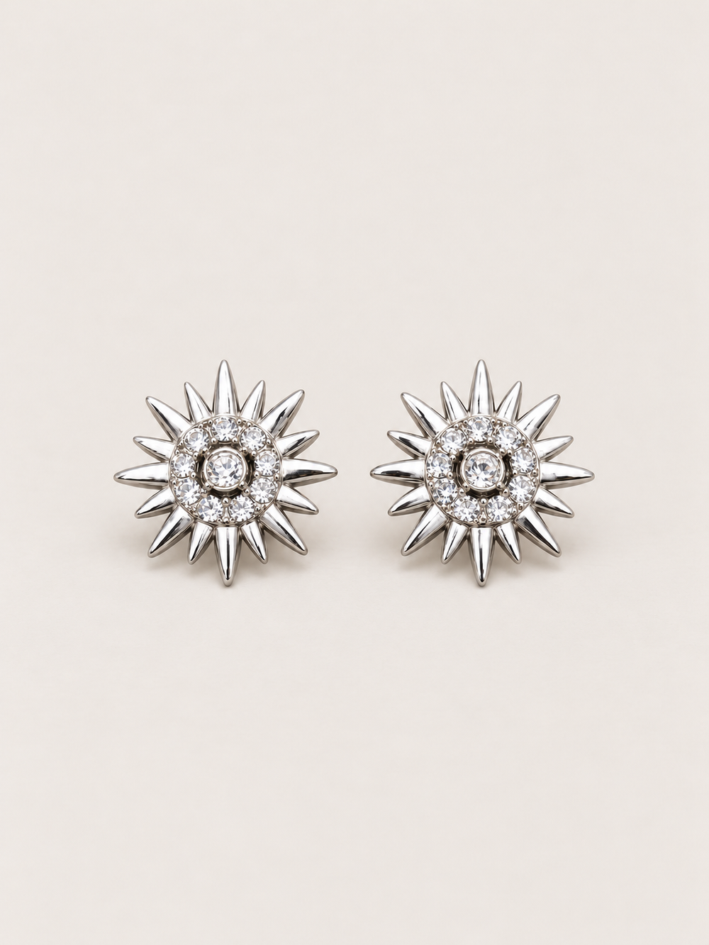Crystal Sunburst Stud Earrings in Silver shown on a warm neutral background