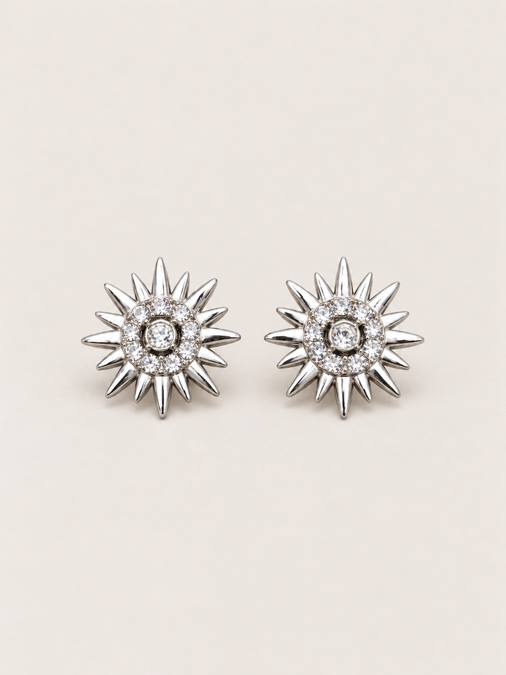 Crystal Sunburst Stud Earrings in Silver shown on a warm neutral background