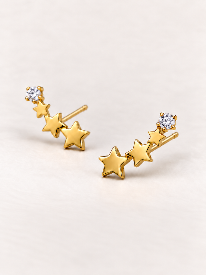 Crystal and Three Star Earrings shown angled on a warm neutral background