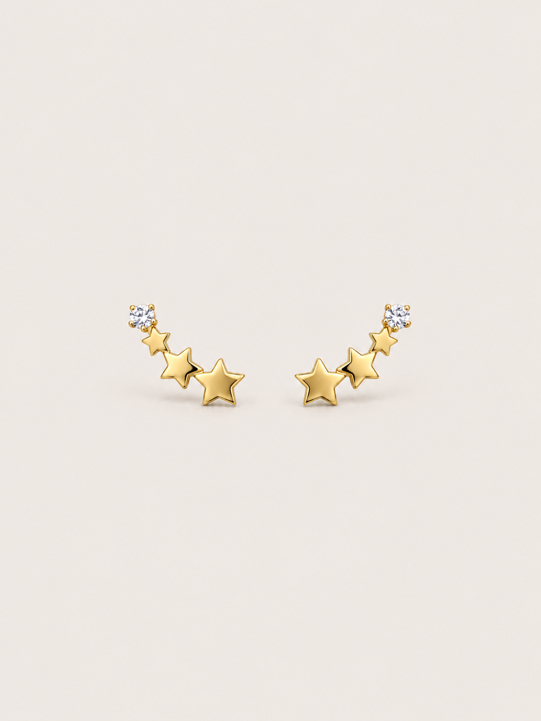 Crystal and Three Star Earrings shown on a warm neutral background