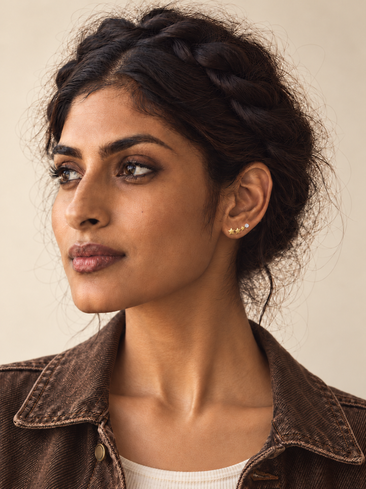 Crystal and Three Star Earrings worn on a model in a brown denim jacket