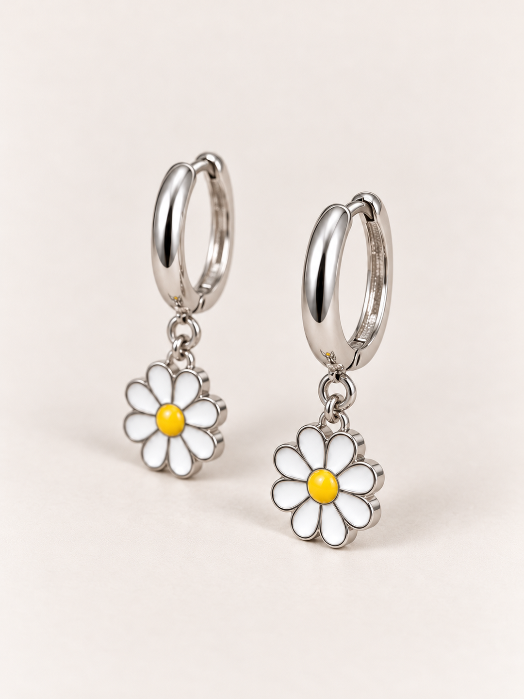 Daisy Hoop Earrings shown at an angle on a warm neutral background