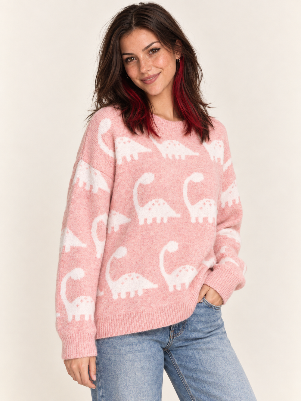 Model wearing pink brontosaurus sweater, angled view