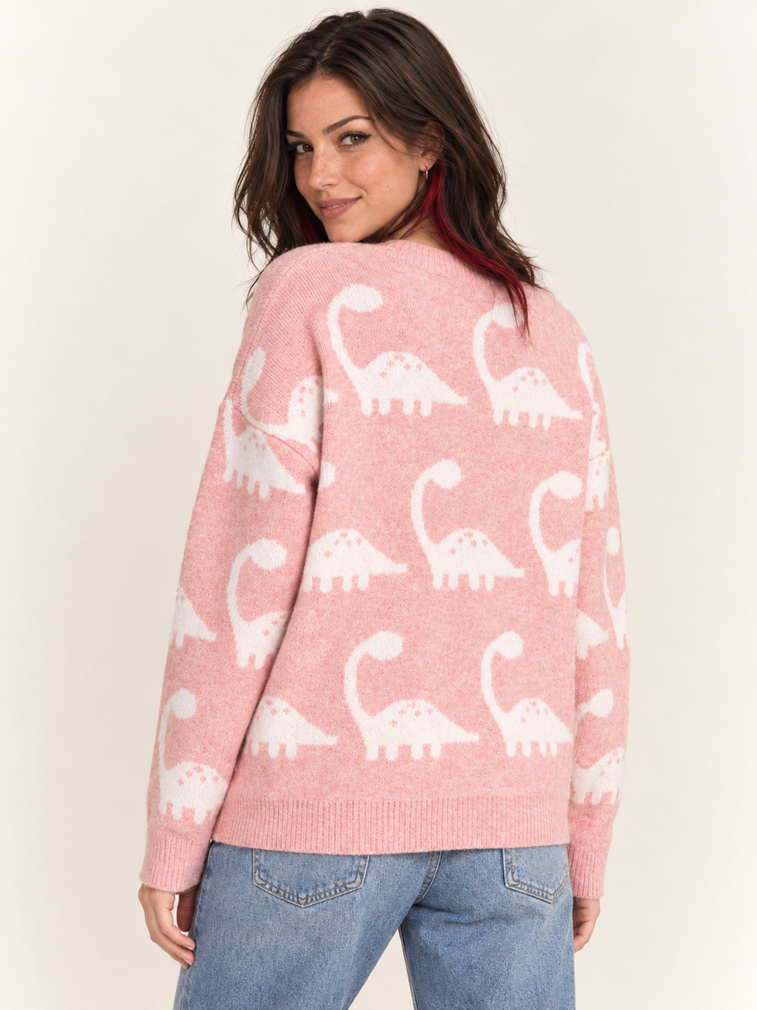 Model wearing pink brontosaurus sweater, back view