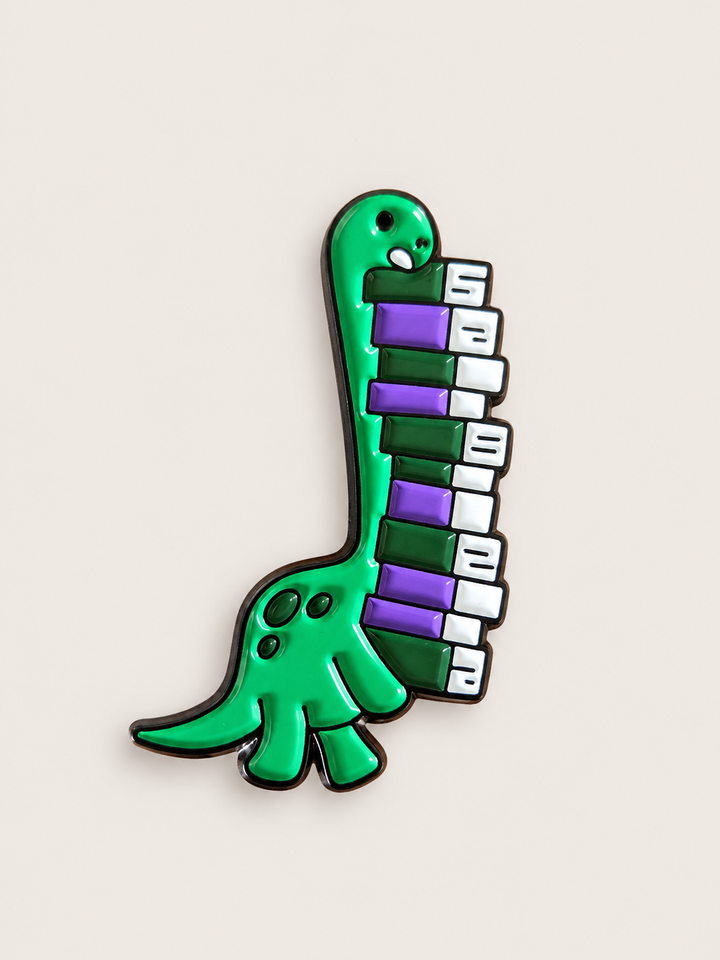 Dinosaur Piano Pin shown on a warm neutral background