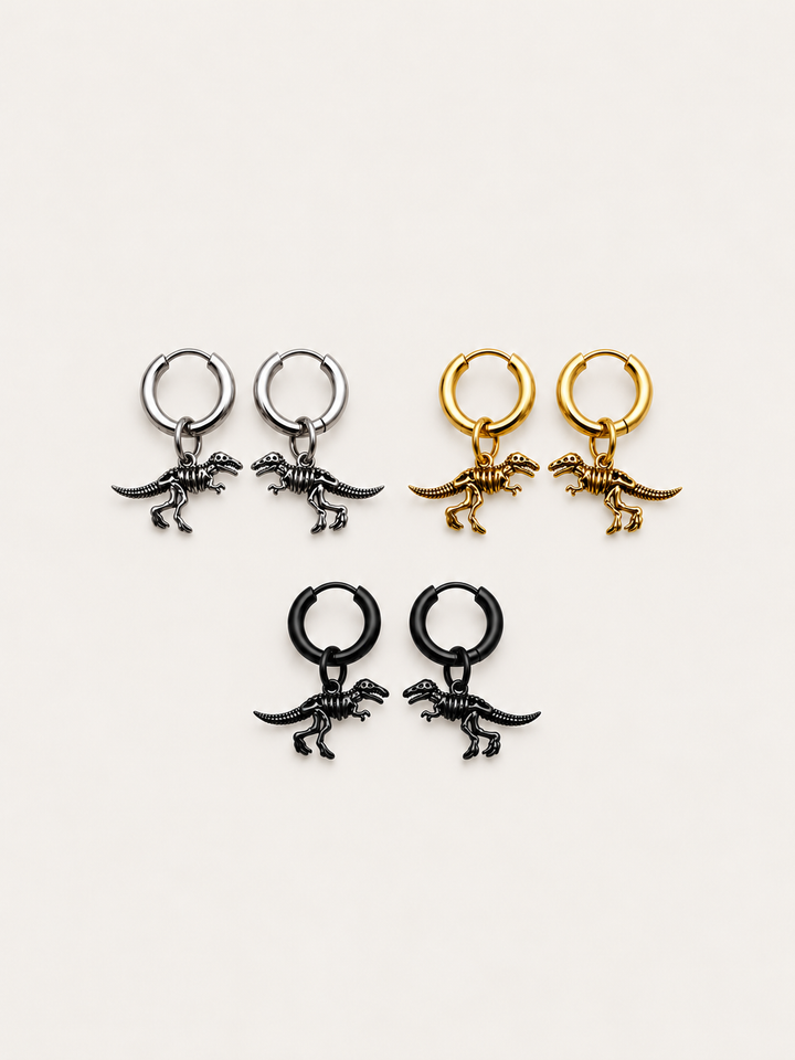 Dinosaur Skeleton Hoop Earrings in silver, gold, and black shown on a warm neutral background
