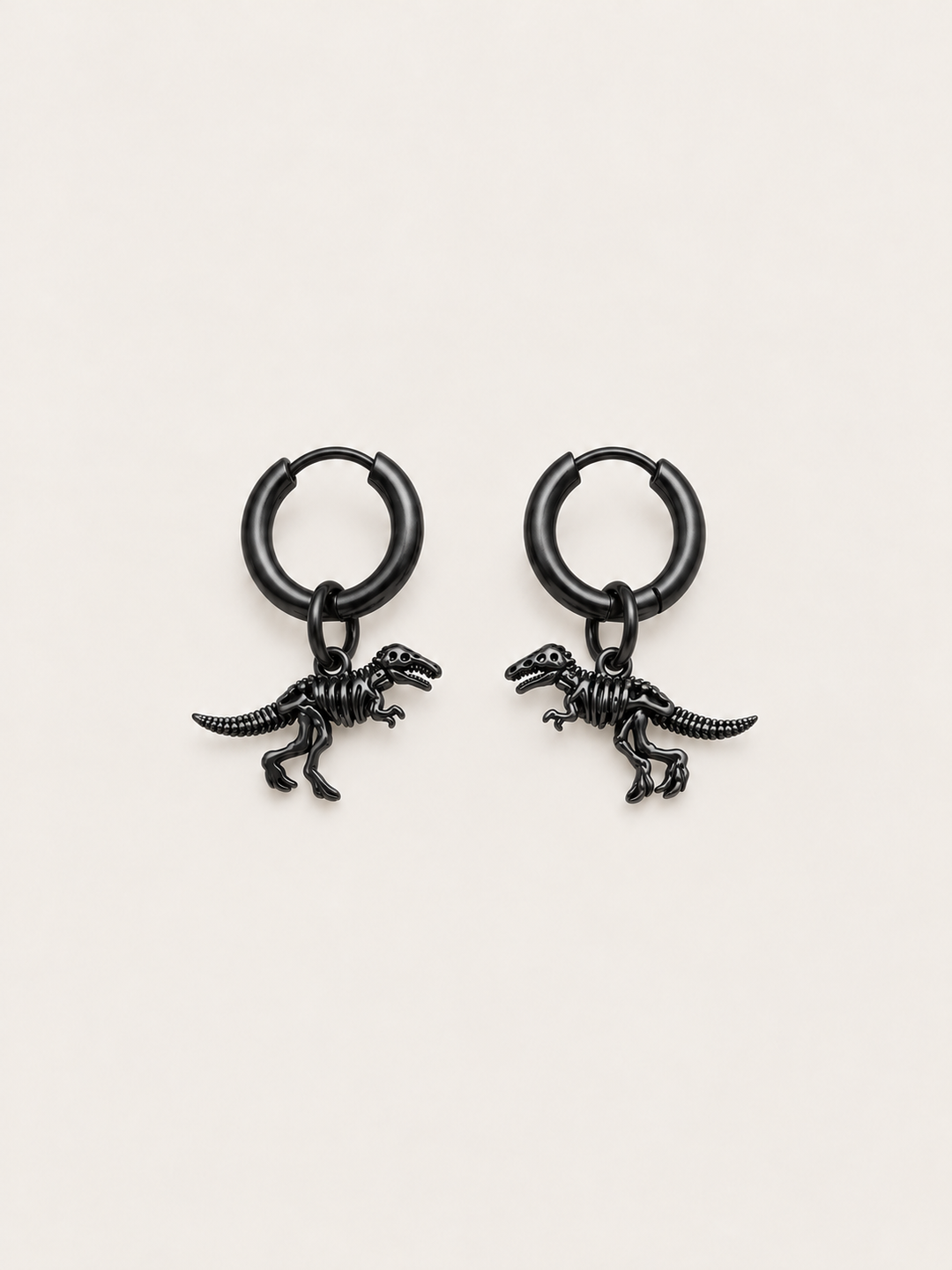 Dinosaur Skeleton Hoop Earrings — black main on a warm neutral background