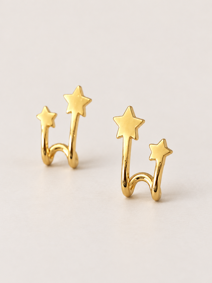 Double Star Wrap Earrings shown angled on a warm neutral background