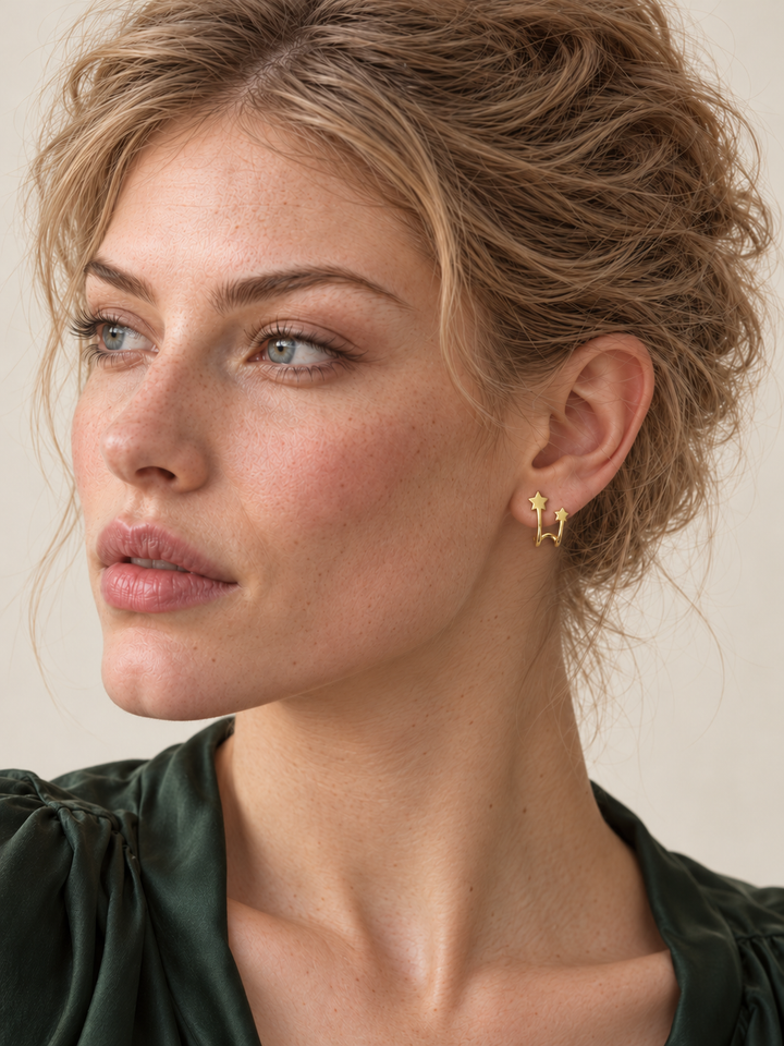 Gold Double Star Wrap Earrings worn with the curved wire beneath the earlobe