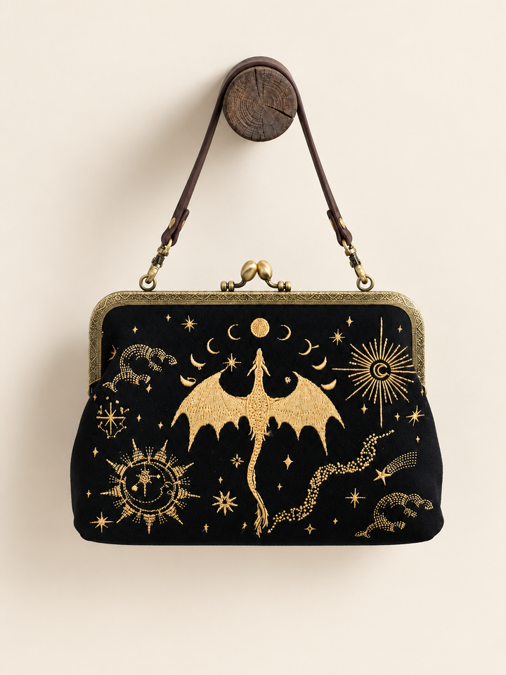 Dragon Kisslock Bag hanging from its short vinyl strap