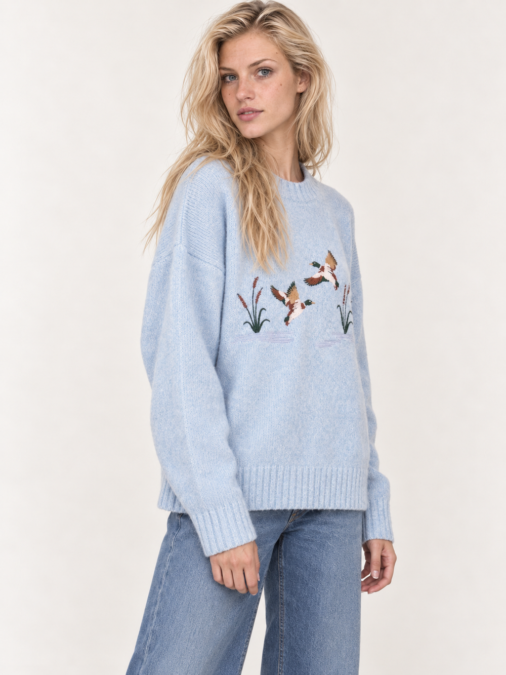 Light blue embroidered ducks sweater three-quarter view