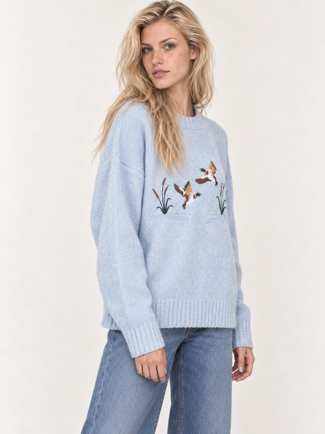 Light blue embroidered ducks sweater three-quarter view