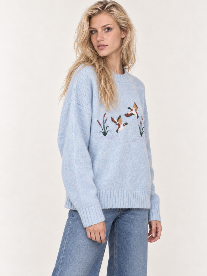 Light blue embroidered ducks sweater three-quarter view