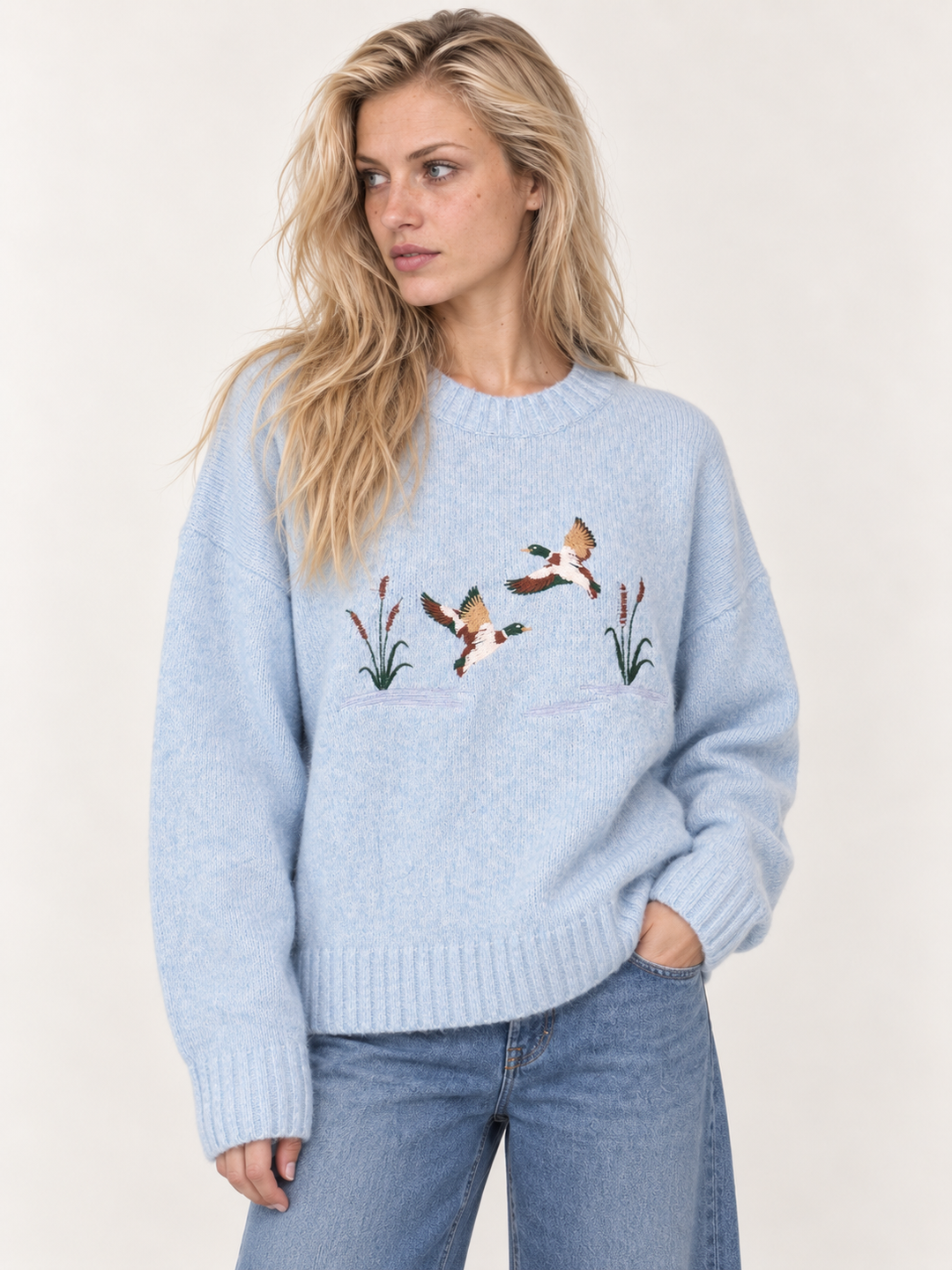 Light blue embroidered ducks sweater front view