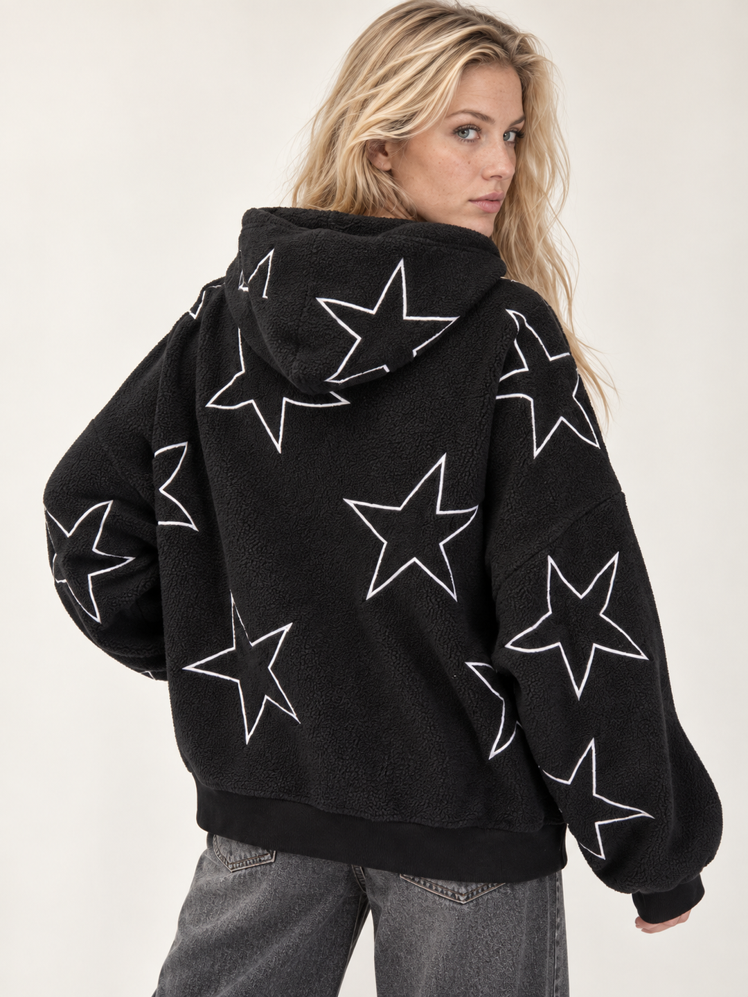 Model wearing the Embroidered Star Sherpa Hoodie Black — back view