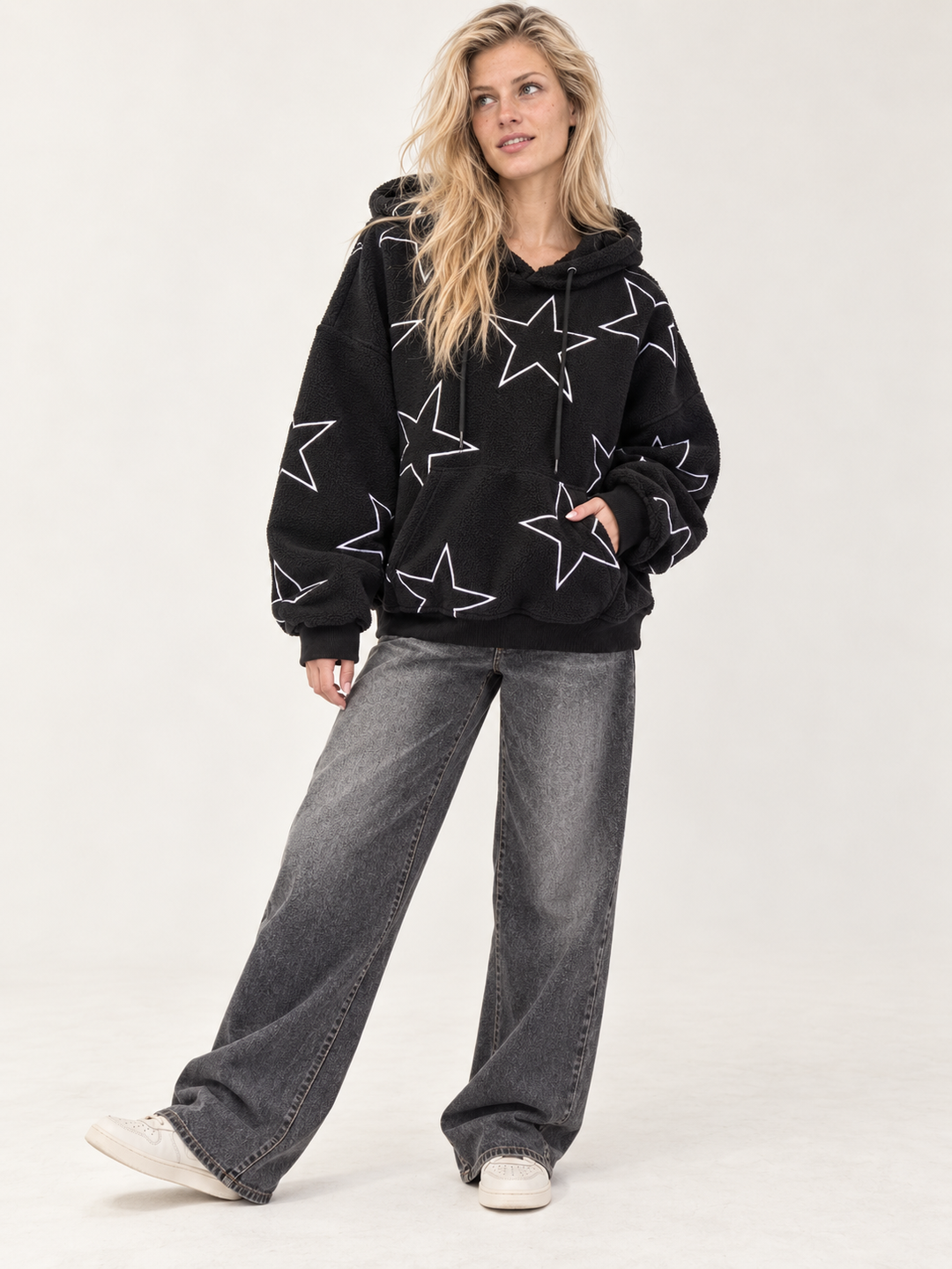 Model wearing the Embroidered Star Sherpa Hoodie Black — full-body view