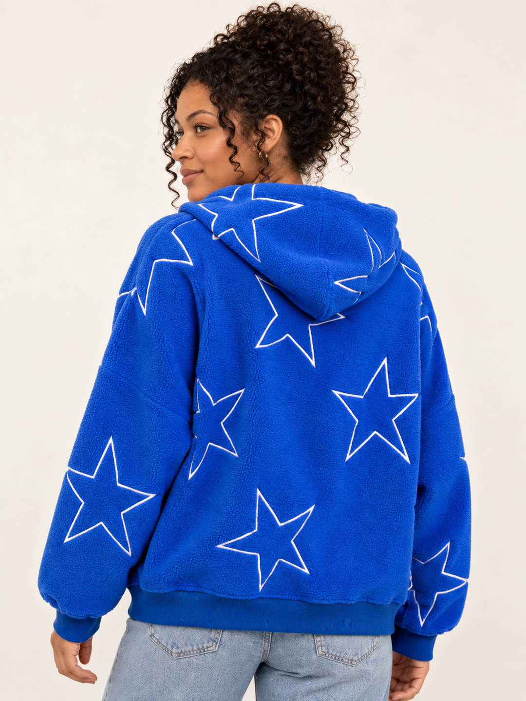 Model wearing Embroidered Star Sherpa Hoodie Blue, back view