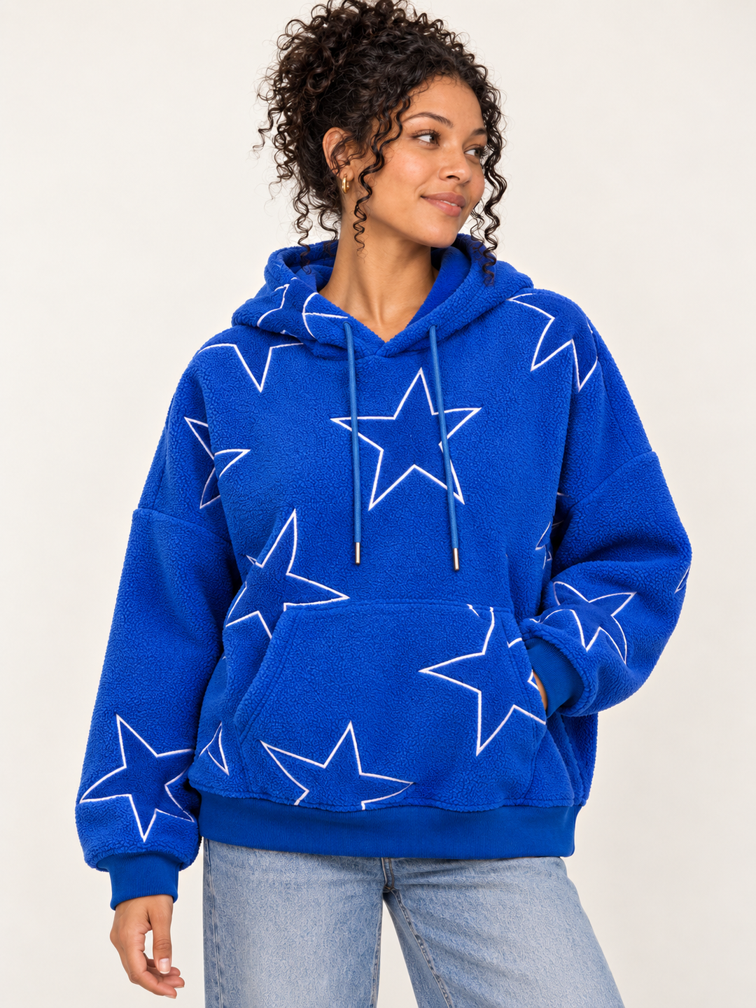 Model wearing Embroidered Star Sherpa Hoodie Blue, front view