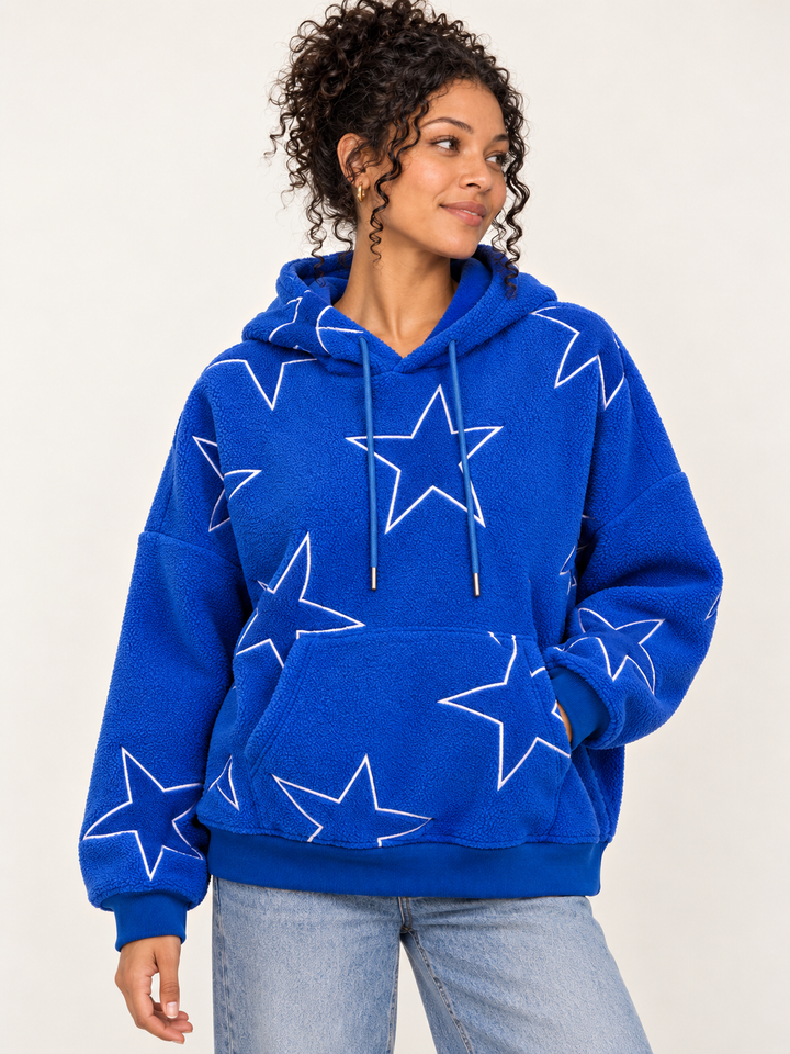 Model wearing Embroidered Star Sherpa Hoodie Blue, front view