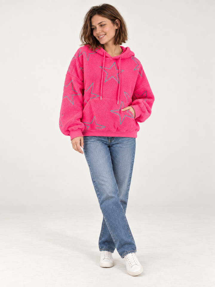 Model wearing embroidered star sherpa hoodie in pink, full body view