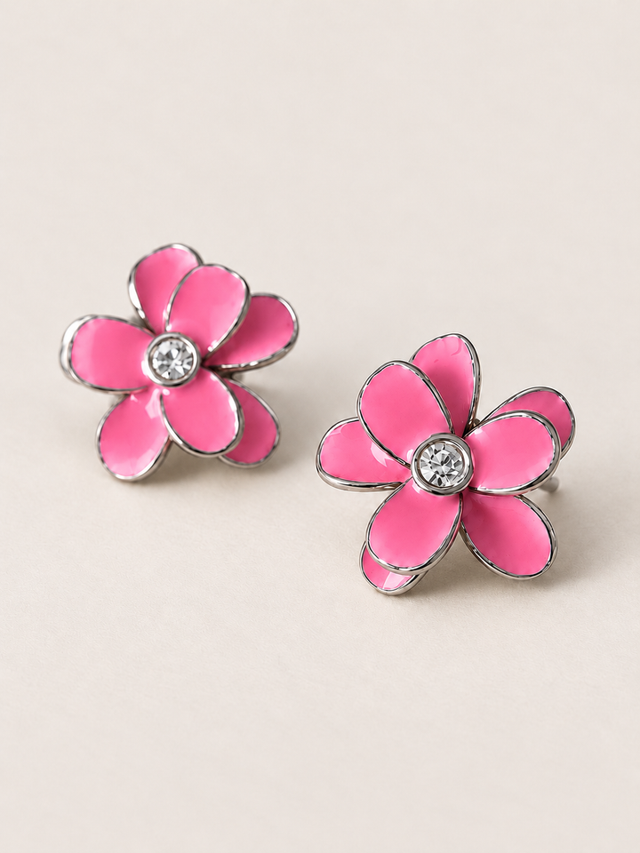 Enamel Flower Stud Earrings pink angle on a warm neutral background