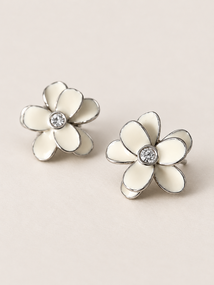 Enamel Flower Stud Earrings white angle on a warm neutral background