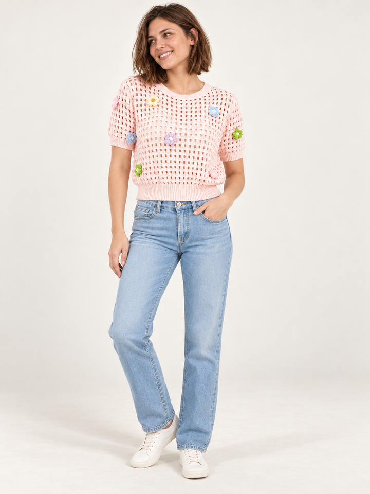 Model wearing Flower Open Knit Short Sleeve Top Pink over an ivory scoop-neck tank, full-body view