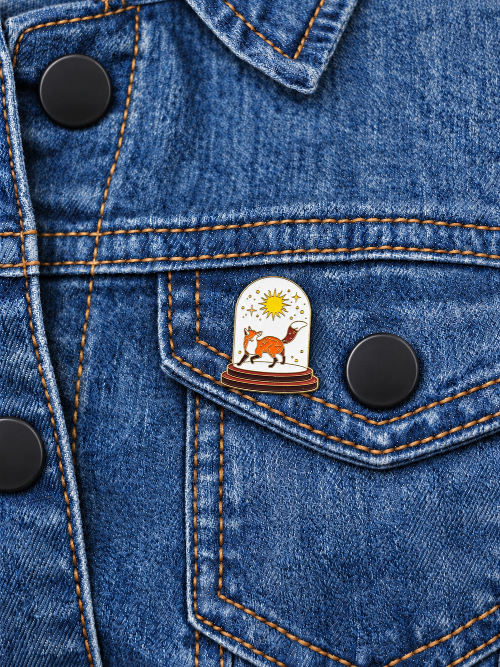 Fox Sun Glass Dome Pin displayed on a medium-blue denim jacket beside a black button