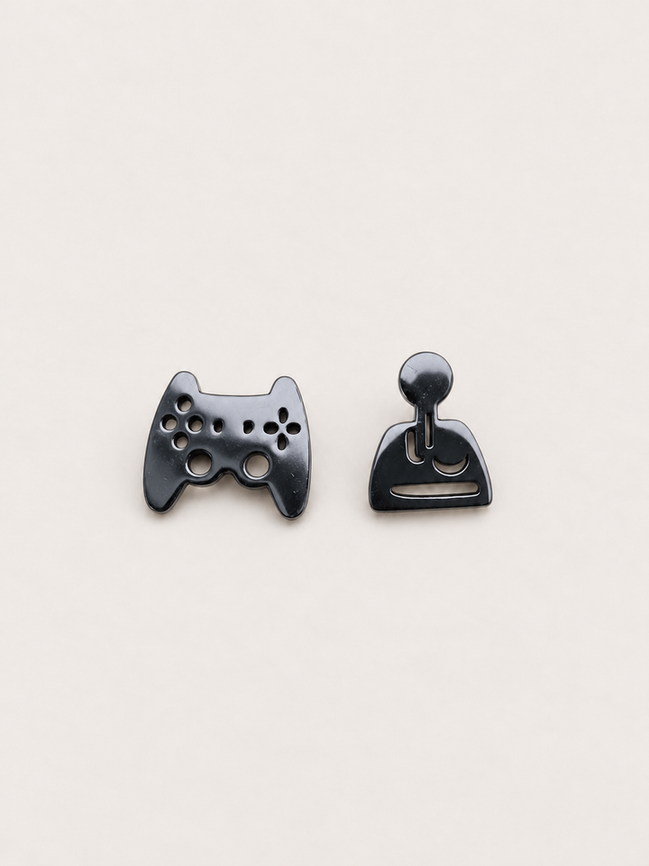 black Game Controller and Joystick Earrings shown on a warm neutral background