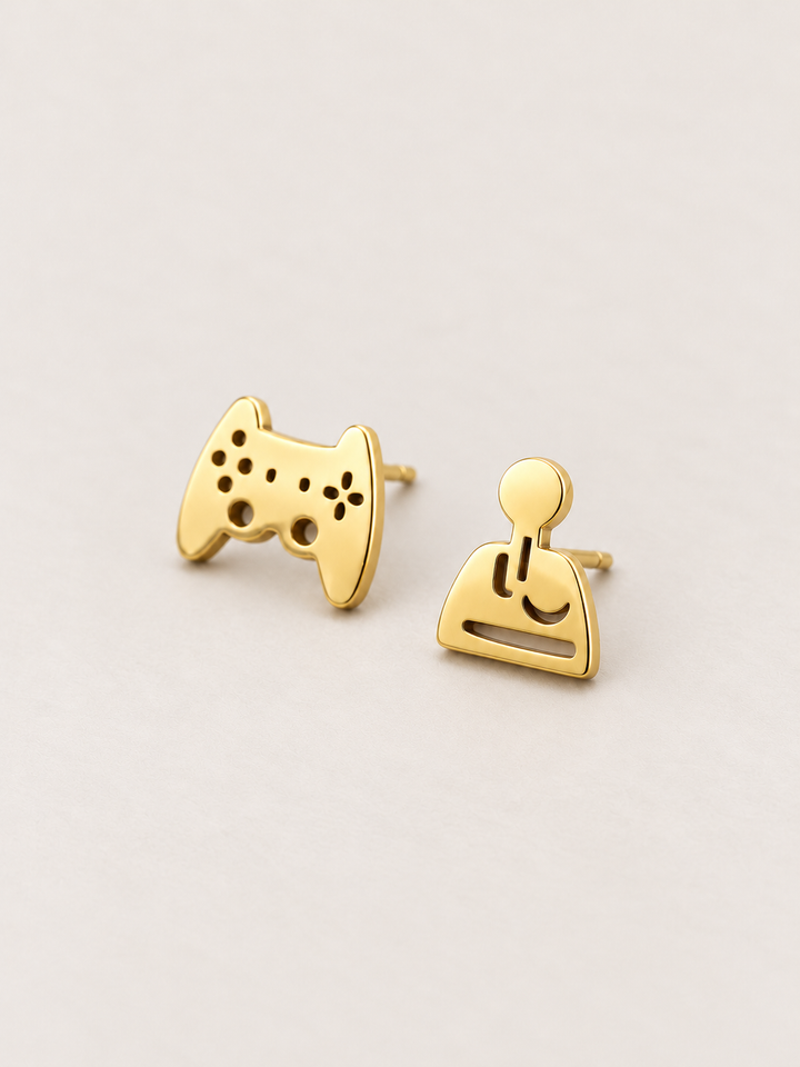 gold Game Controller and Joystick Earrings shown angled on a warm neutral background