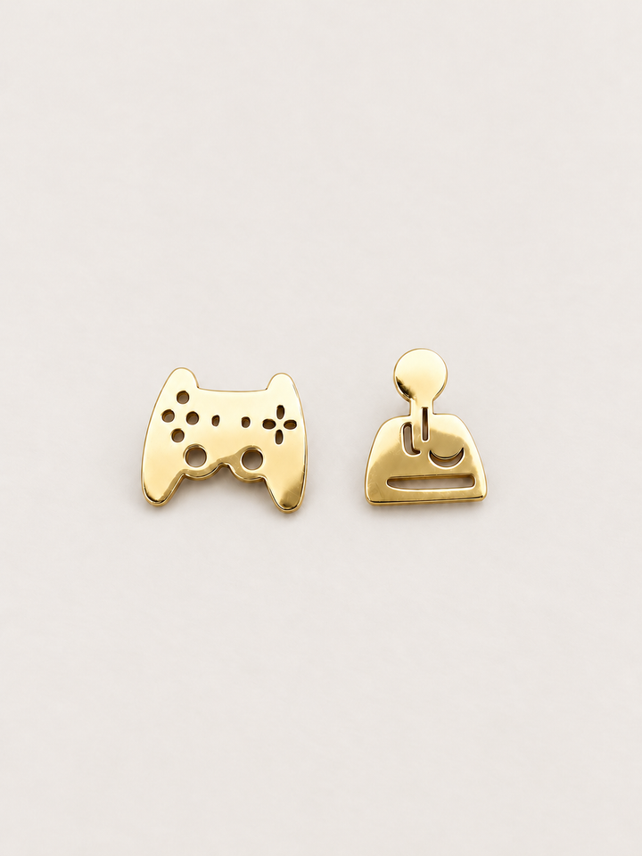 gold Game Controller and Joystick Earrings shown on a warm neutral background