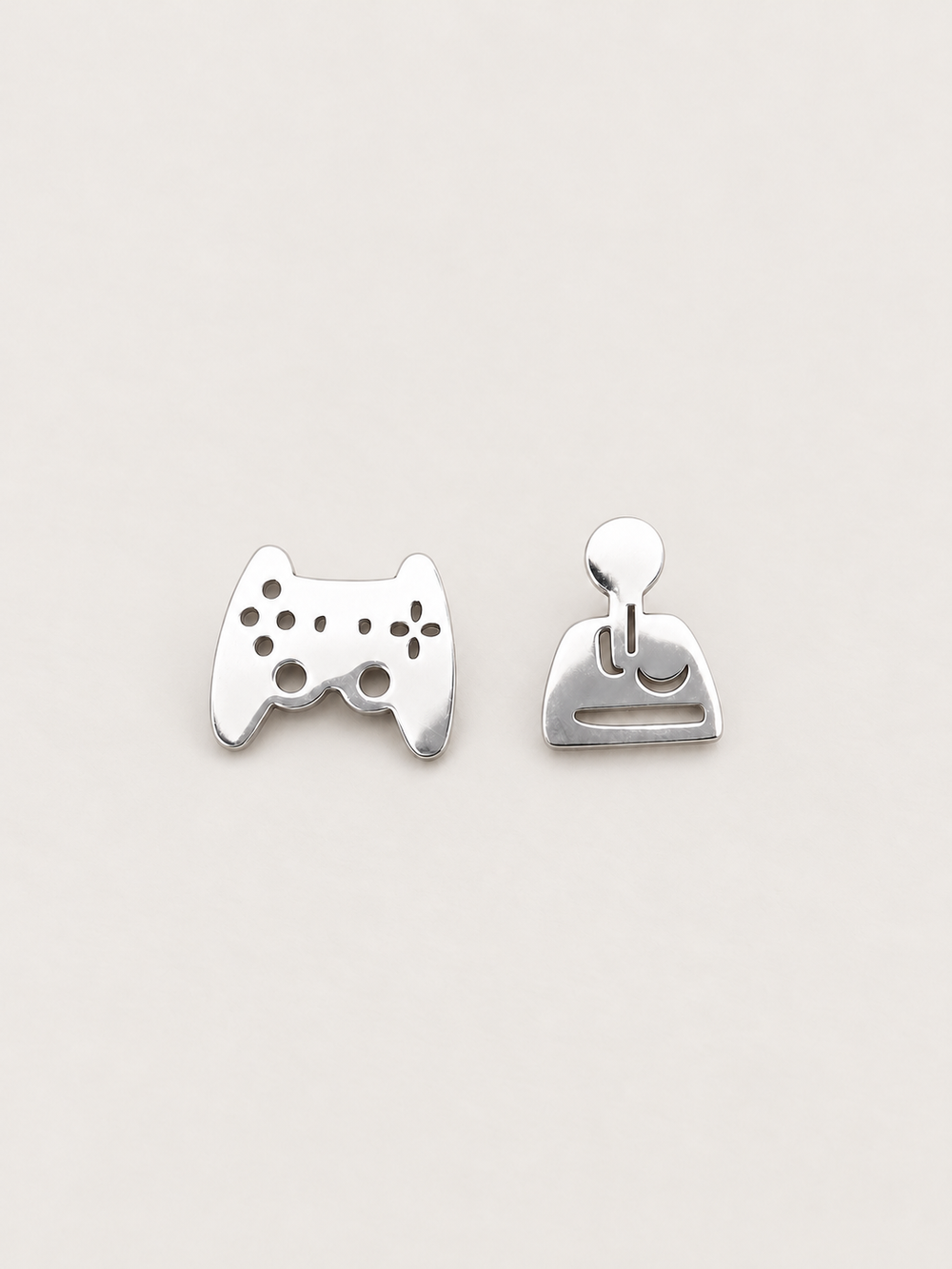 silver Game Controller and Joystick Earrings shown on a warm neutral background
